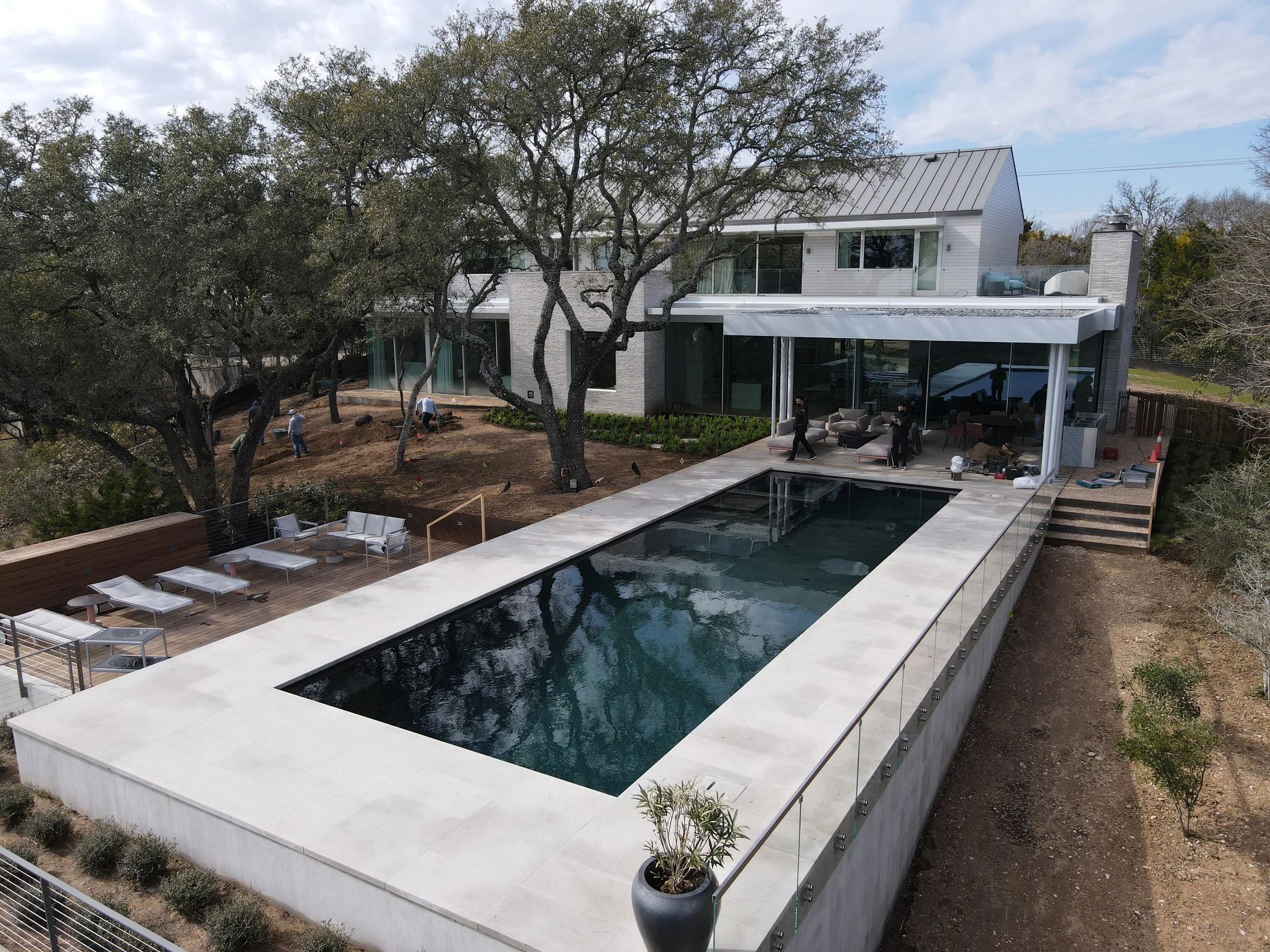 Gunite pool with tile and coping set into a Hill Country patio