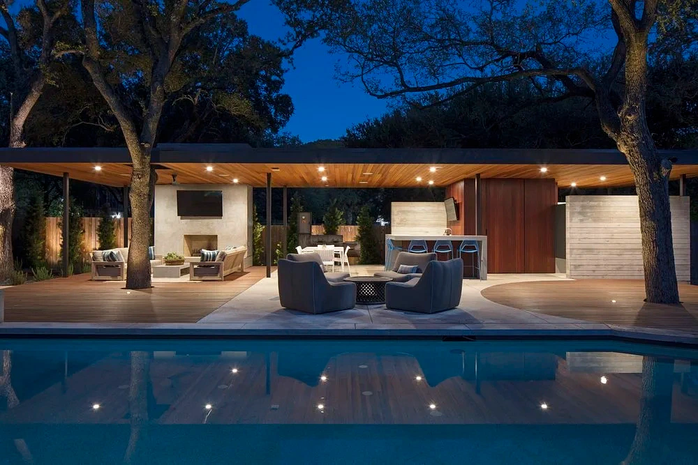 Small pool and outdoor living space lit at dusk near Austin